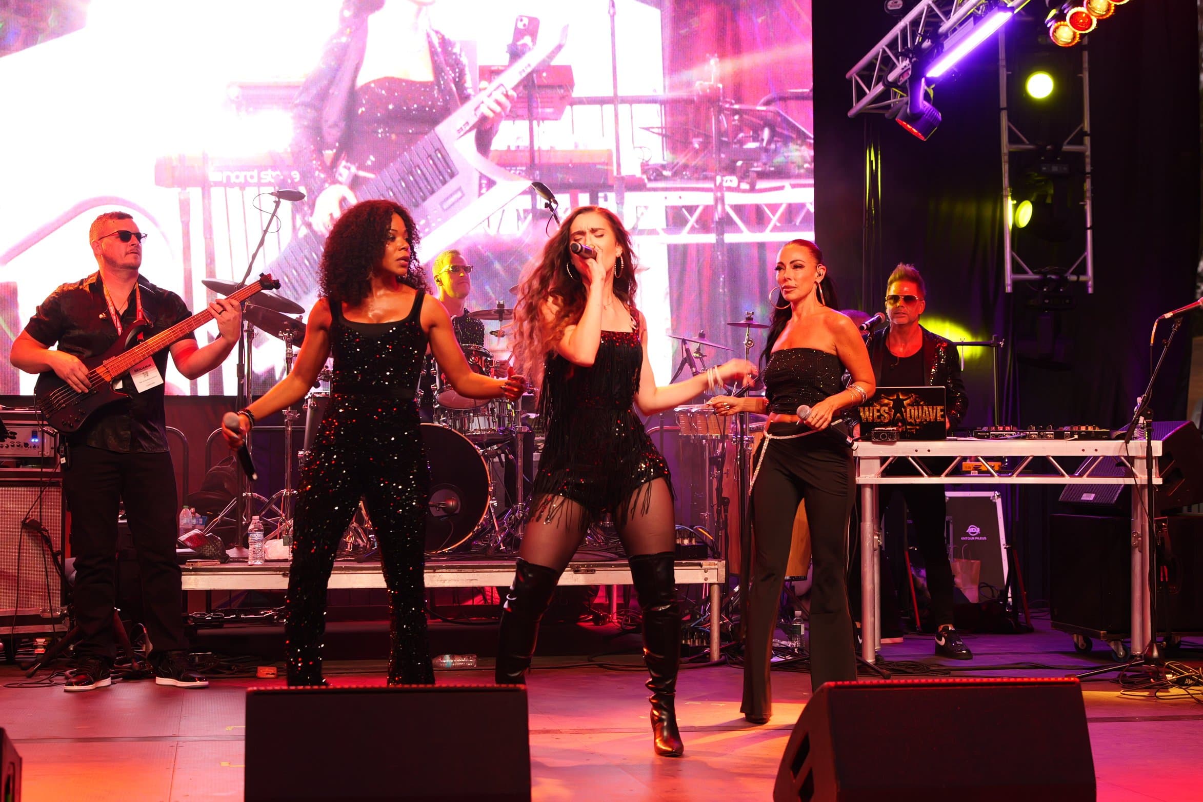 Rebelle singing live on stage with her band